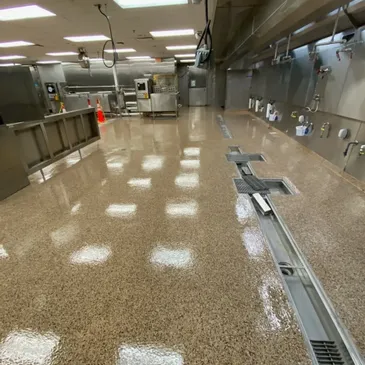 Empty commercial kitchen with polished epoxy floor