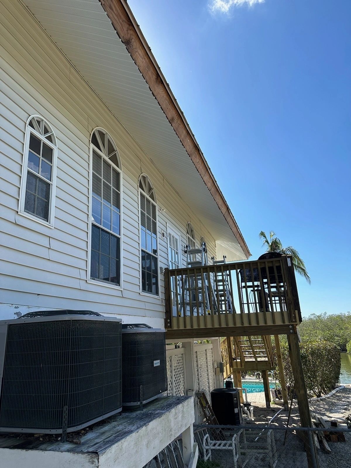 House side with arched windows and deck