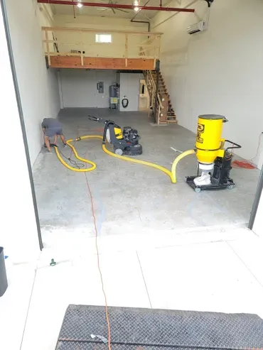 Concrete floor grinding equipment and worker inside
