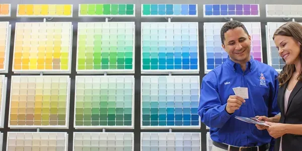 Two people selecting paint color swatches