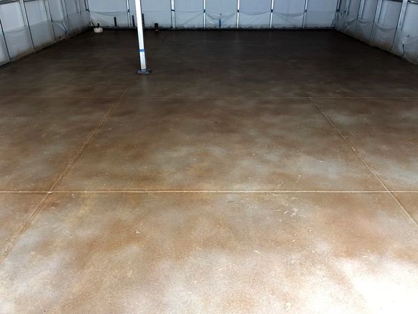 Empty garage interior with stained concrete floor