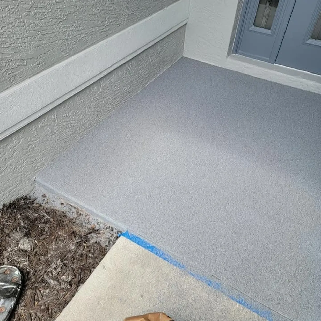 Freshly coated gray porch floor at doorway