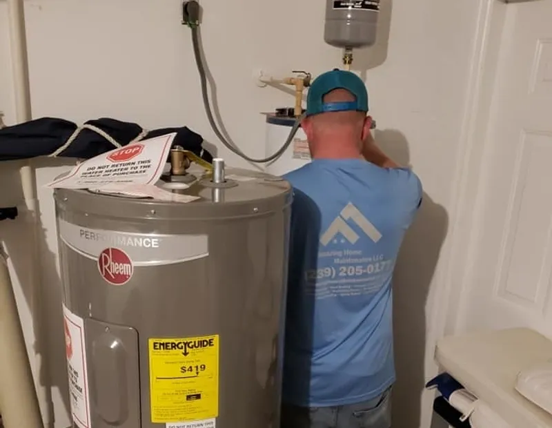 Technician servicing water heater in utility room