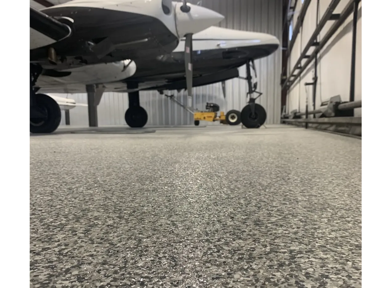 Low-angle view of airplane landing gear in hangar
