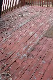 Weathered red wooden deck with peeling paint