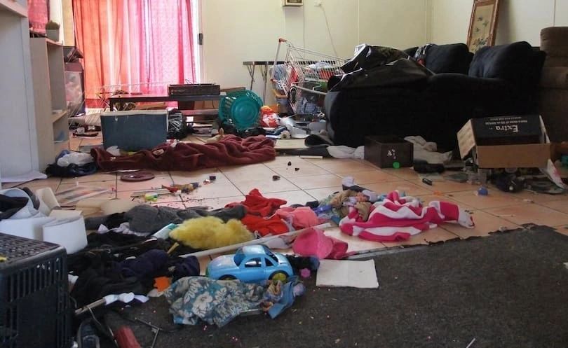 Messy living room with scattered toys and clutter