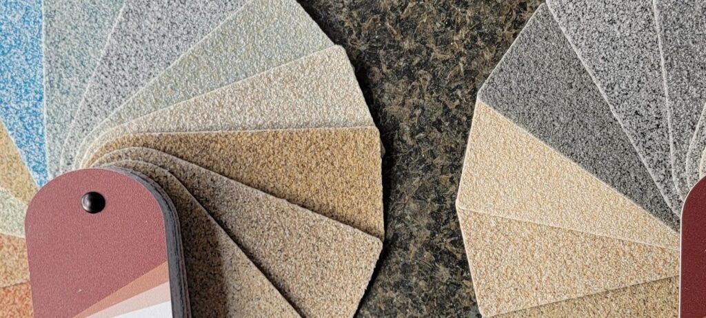 Textured color sample swatches fanned on countertop