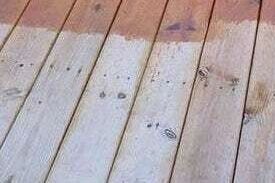 Partially painted wooden deck planks