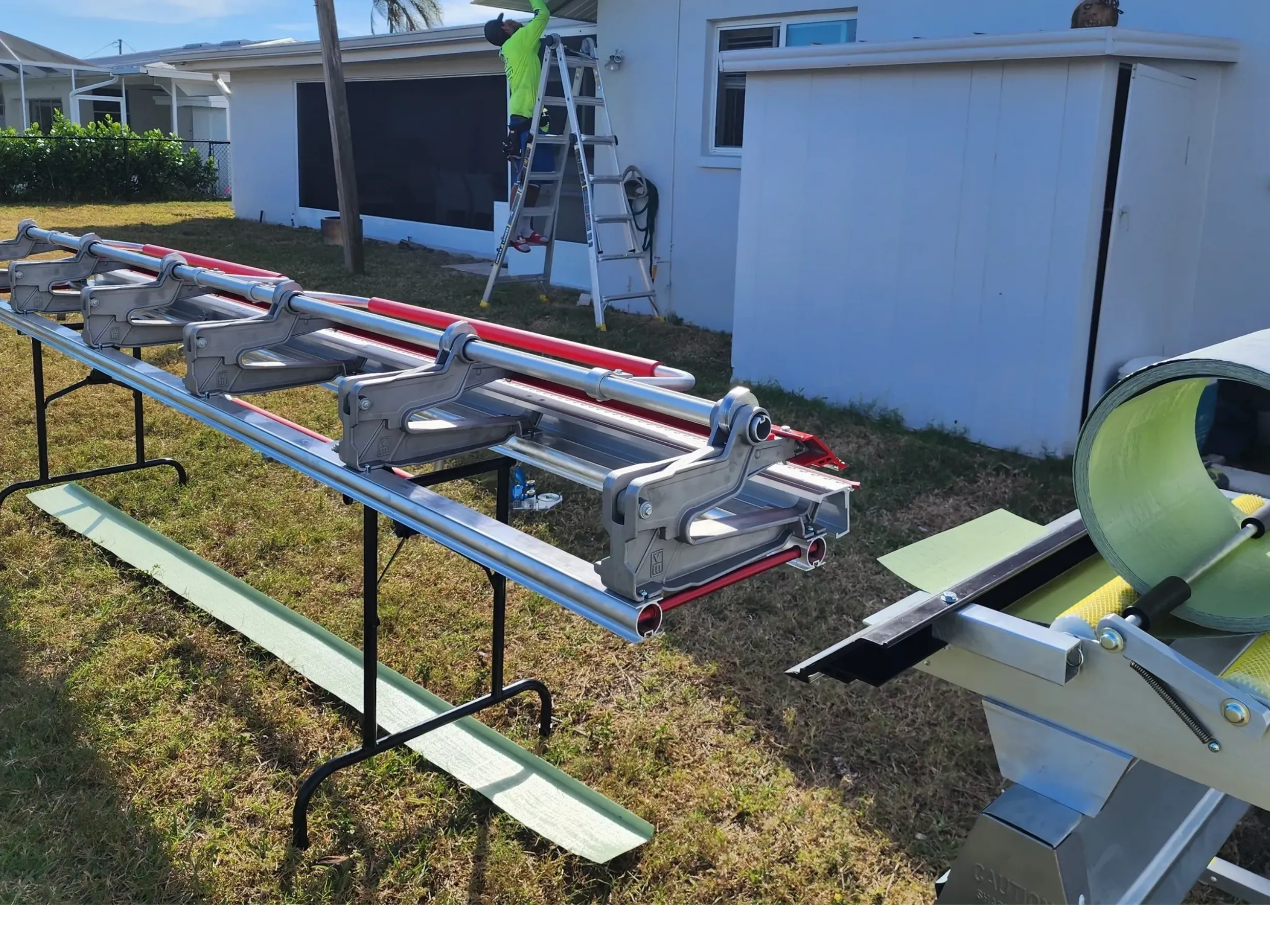 Gutter installation equipment and worker on ladder