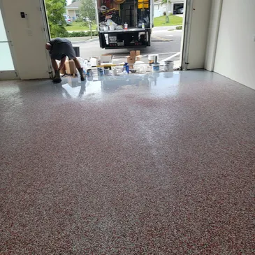 Epoxy flake garage floor being installed
