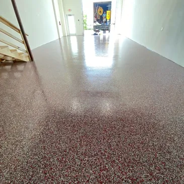 Shiny red and gray speckled epoxy garage floor