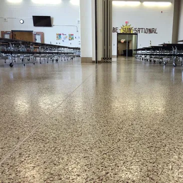 Empty school cafeteria with polished speckled floor