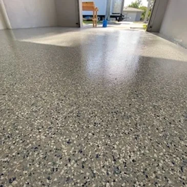Speckled epoxy garage floor with glossy finish