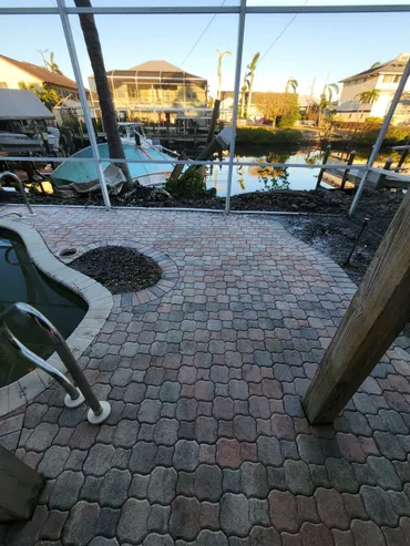 Screened patio with pool steps overlooking canal
