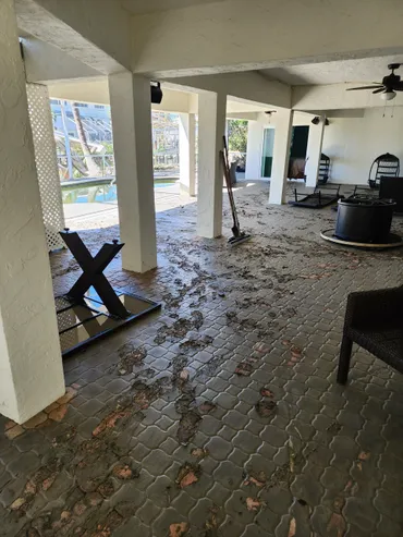 Covered patio with damaged brick pavers