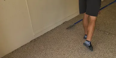 Person's legs and shoes on beige carpet