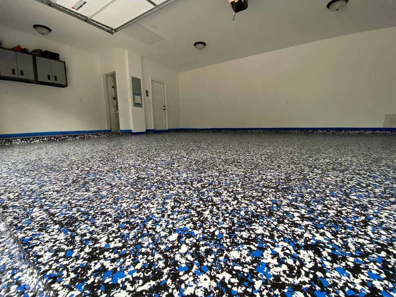 Empty garage with blue and white flake floor