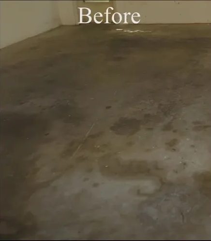 Stained concrete garage floor before cleaning