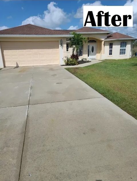 Clean concrete driveway leading to house