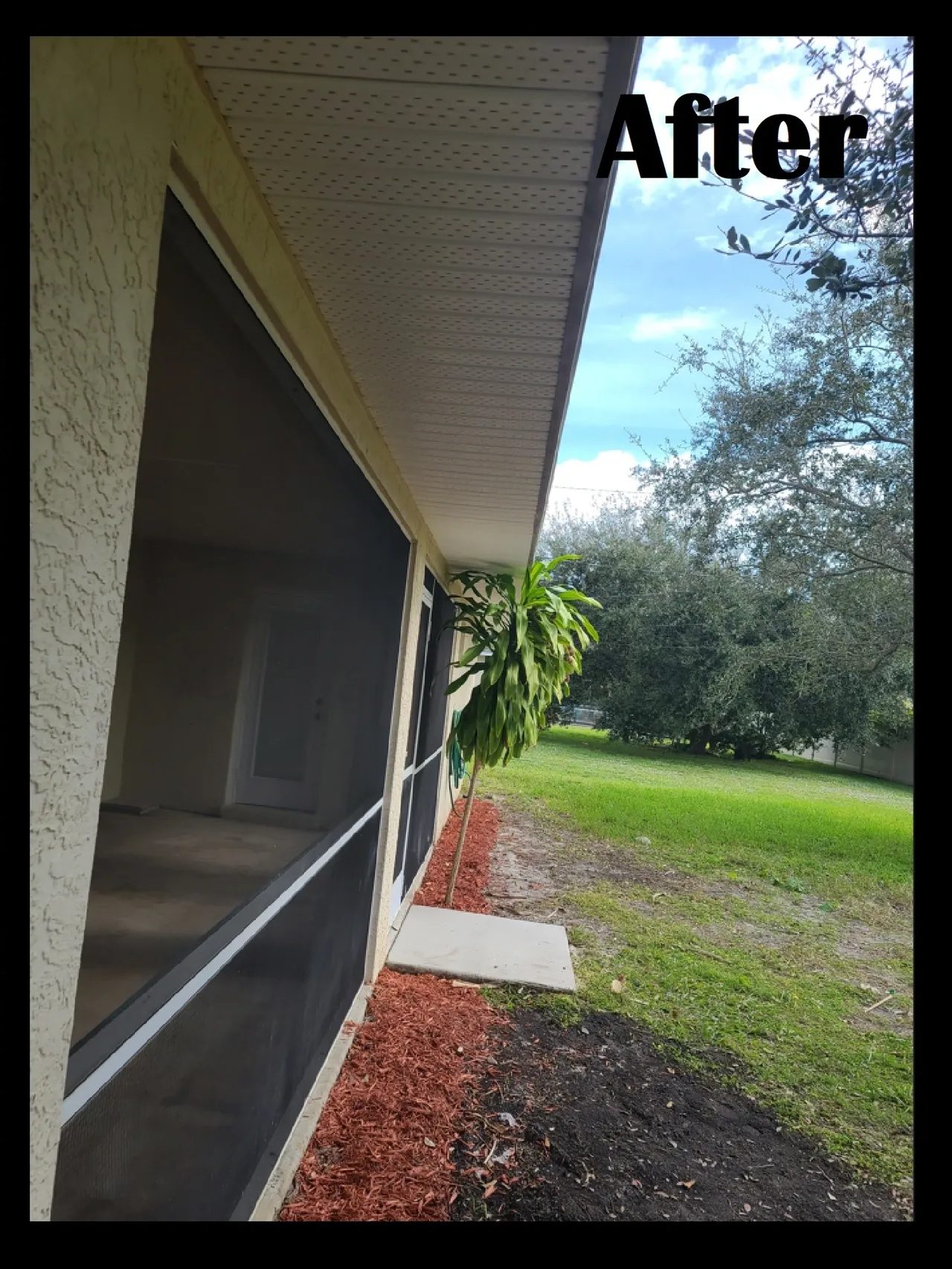 Clean screened porch with fresh red mulch