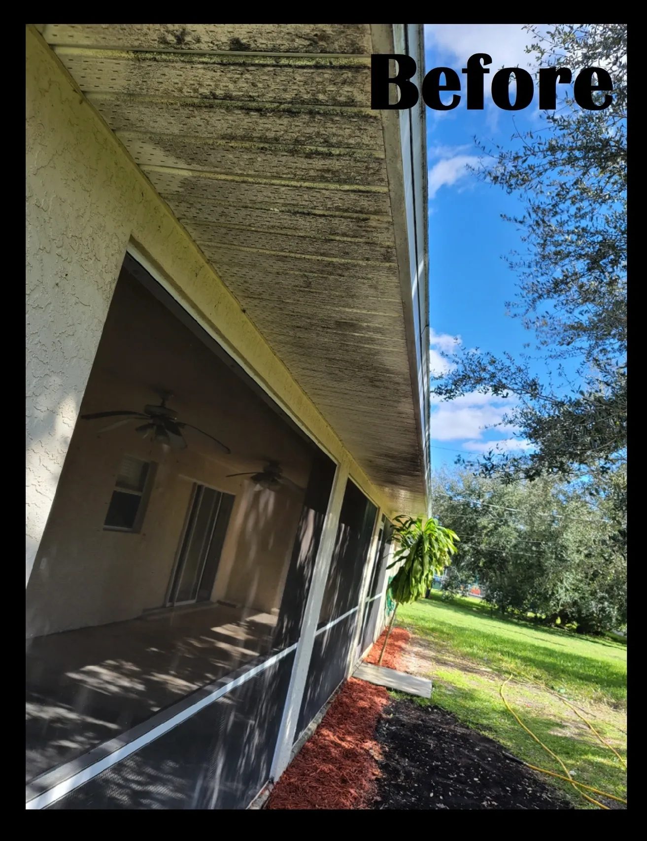 Dirty soffit over screened porch before cleaning