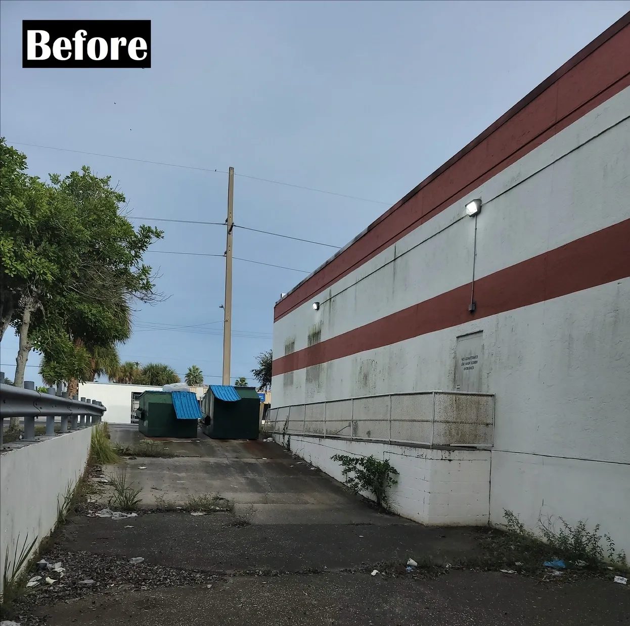 Back alley with dumpsters behind commercial building