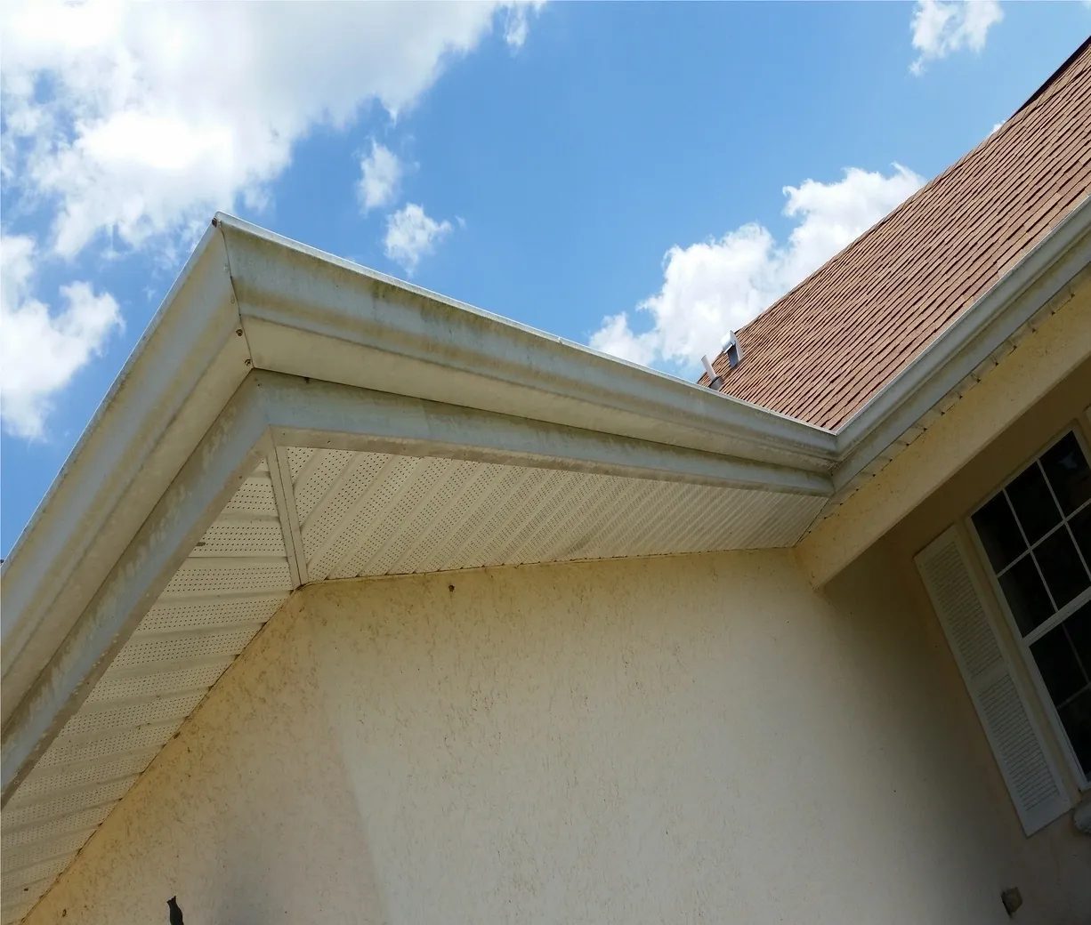 House eaves and gutter under blue sky