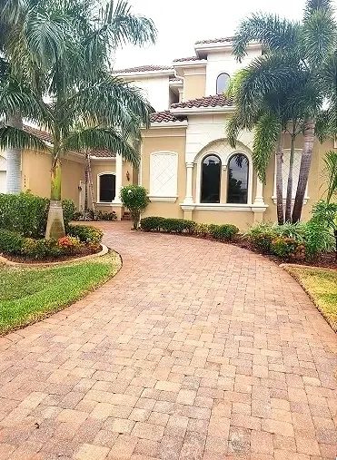 Luxury Mediterranean house with palm-lined driveway