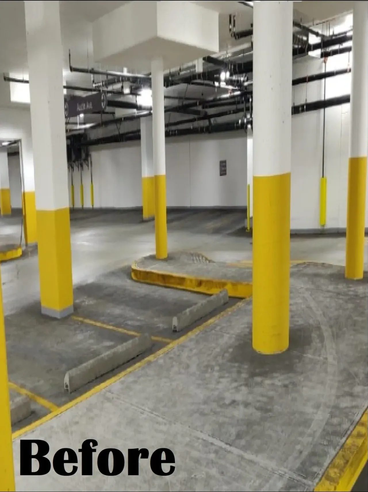 Empty underground parking garage with yellow pillars
