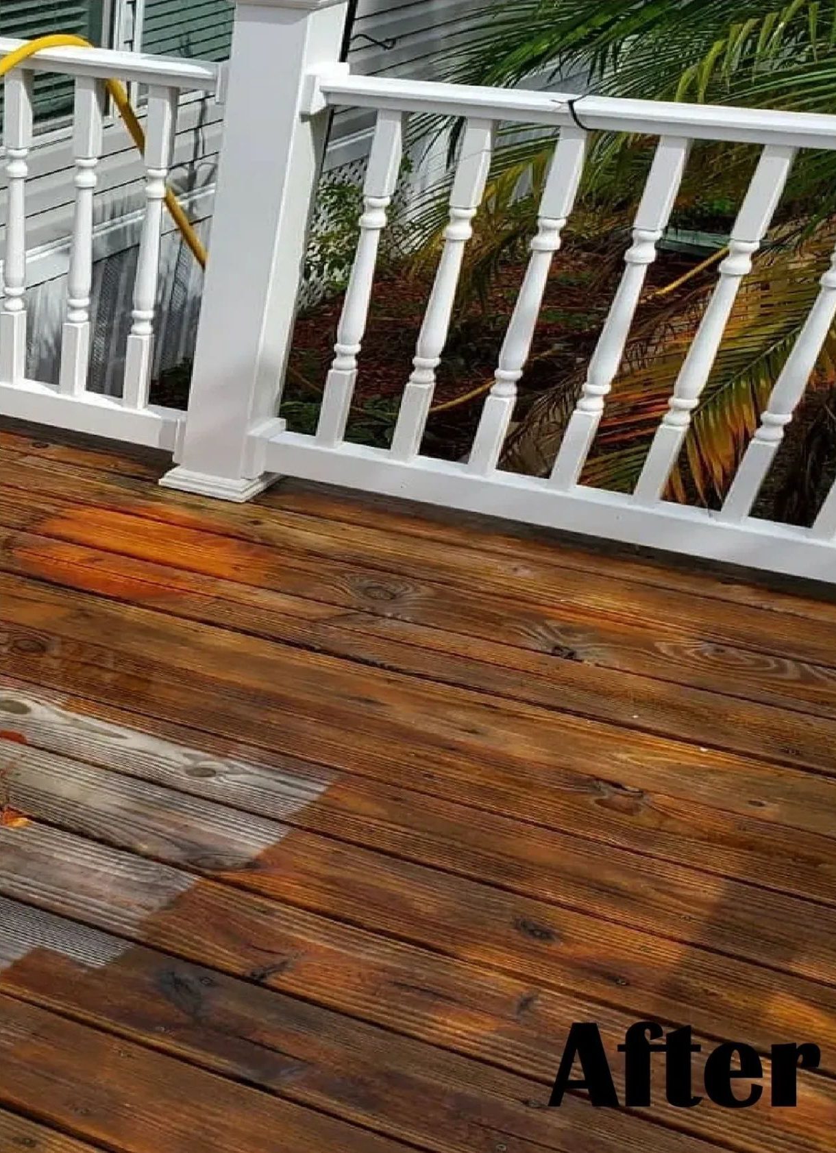 Refinished wooden deck with white railing