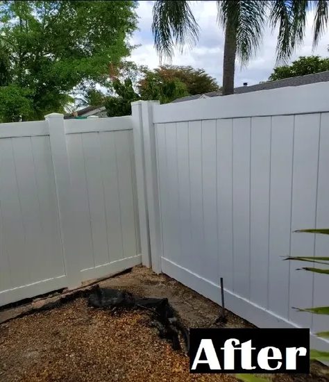 White vinyl fence corner with cleared ground