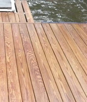 Wooden dock planks beside rippling water