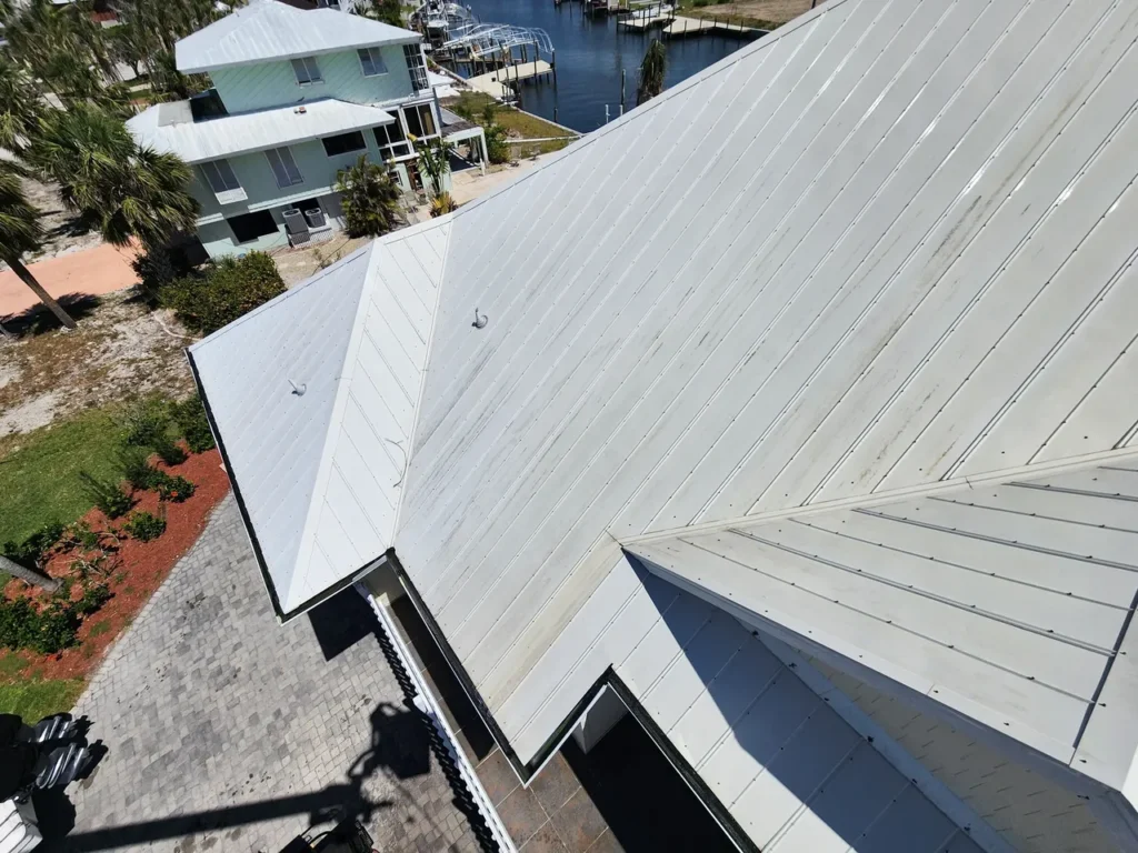 Aerial view of white metal roofs near marina