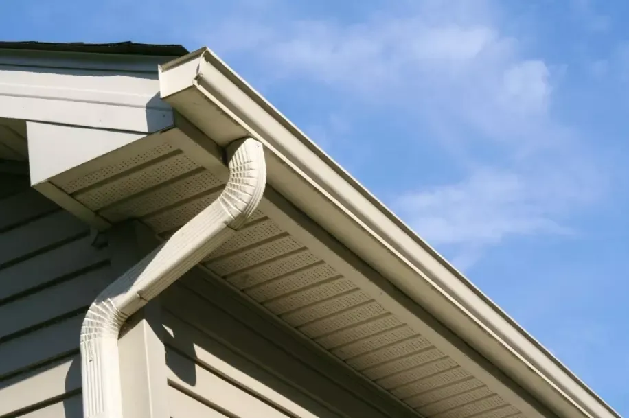 House roof edge with gutter and downspout
