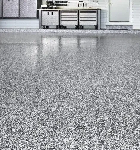 Polished speckled epoxy garage floor with cabinets
