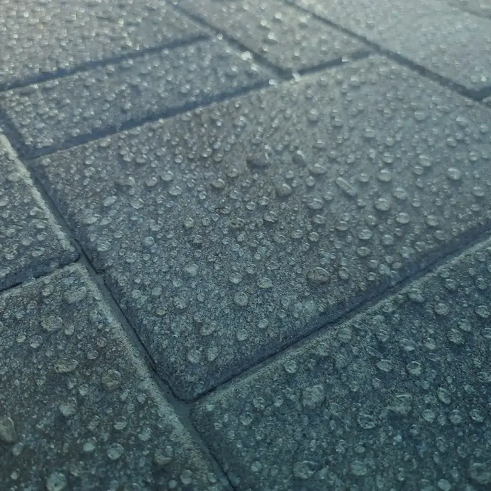Water droplets on gray stone pavers