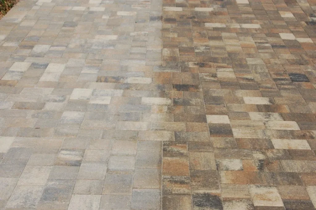 Half-clean, half-dirty paving stone driveway