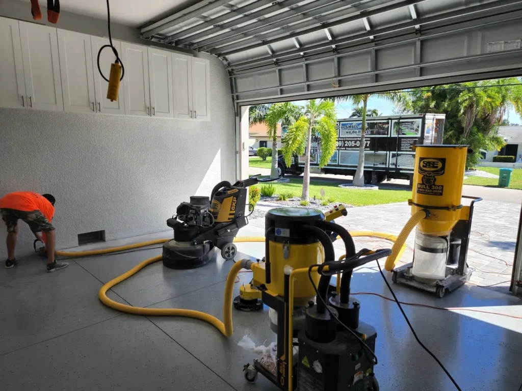 Garage floor resurfacing equipment and worker
