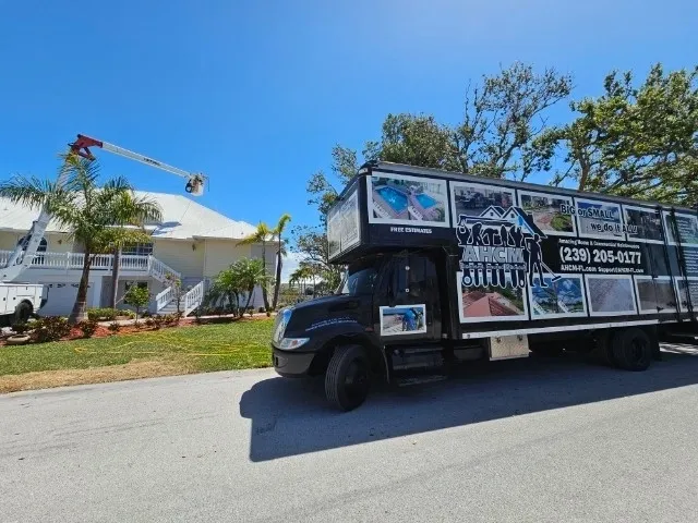 Moving truck parked by house with cherry picker
