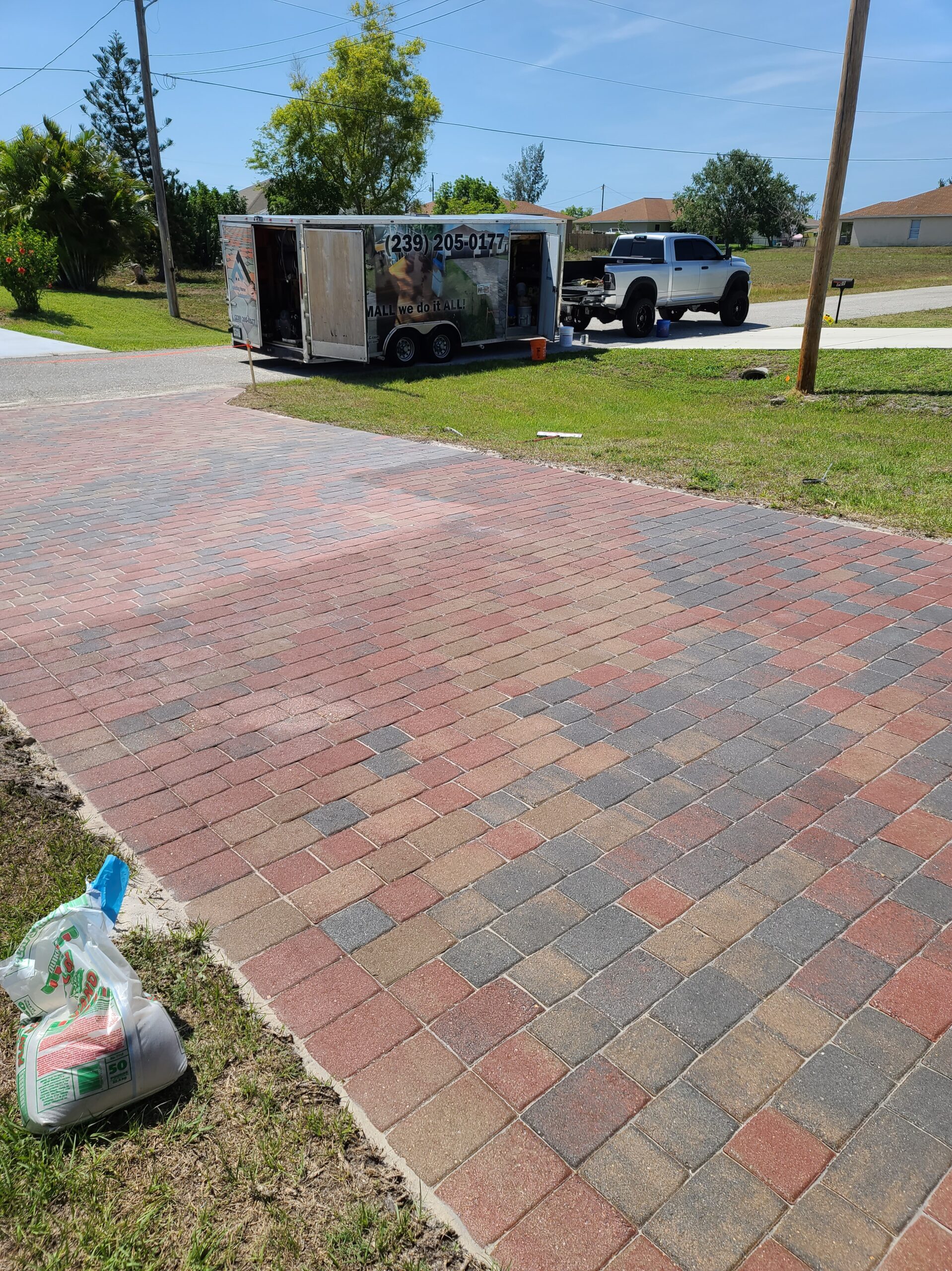 New paver driveway with work truck and trailer
