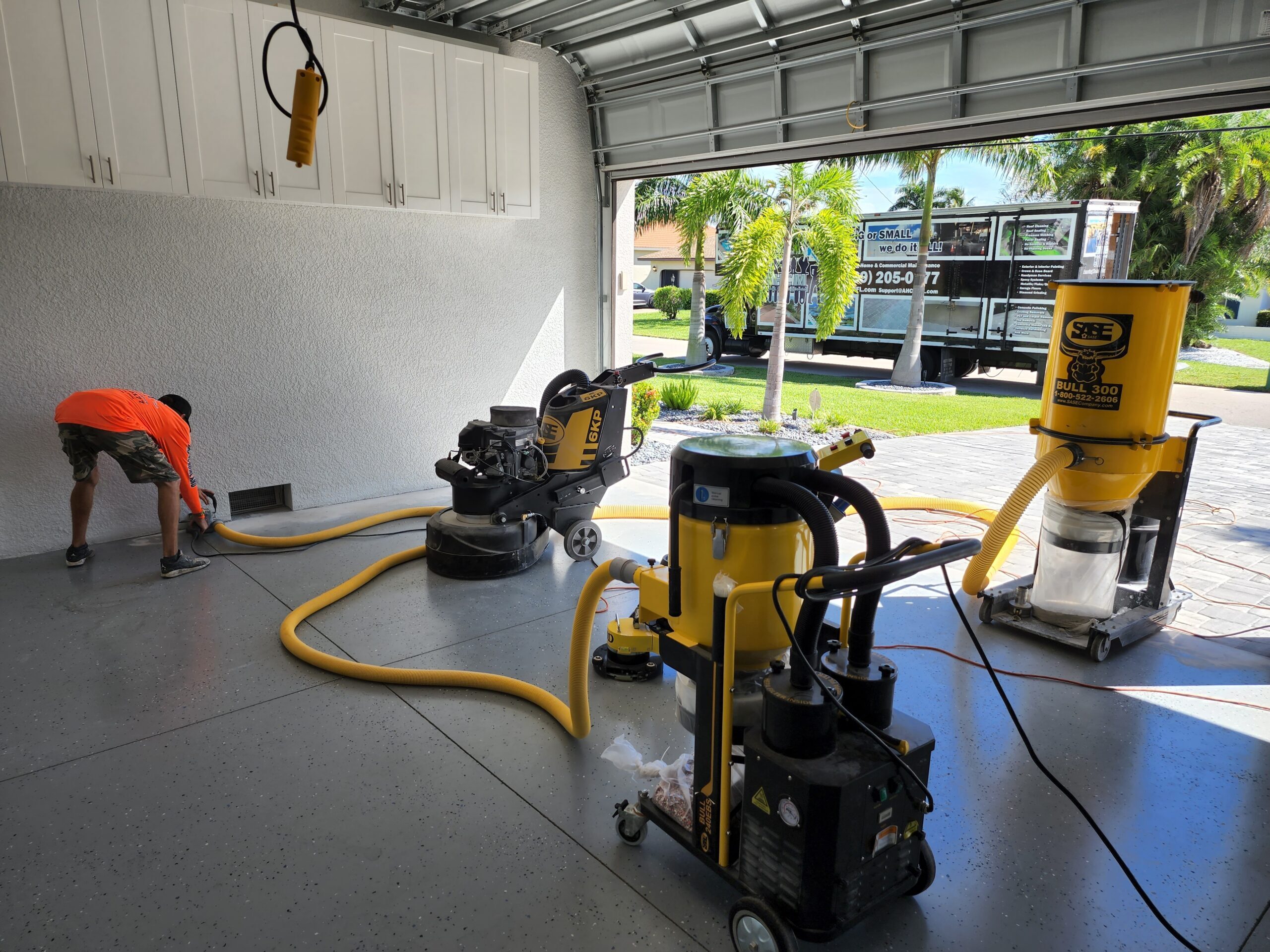 Garage floor polishing equipment and worker