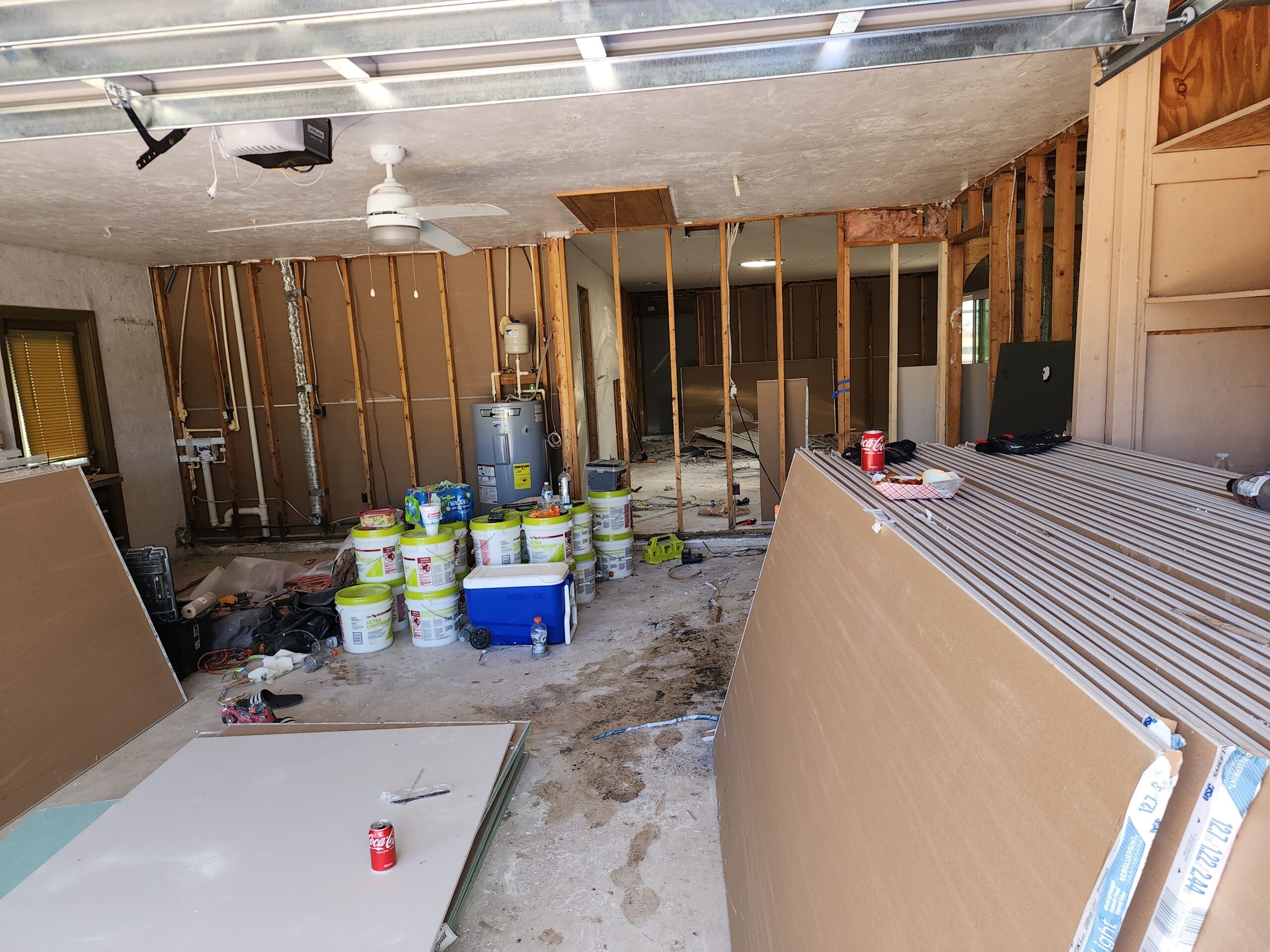 Garage under renovation with drywall and supplies