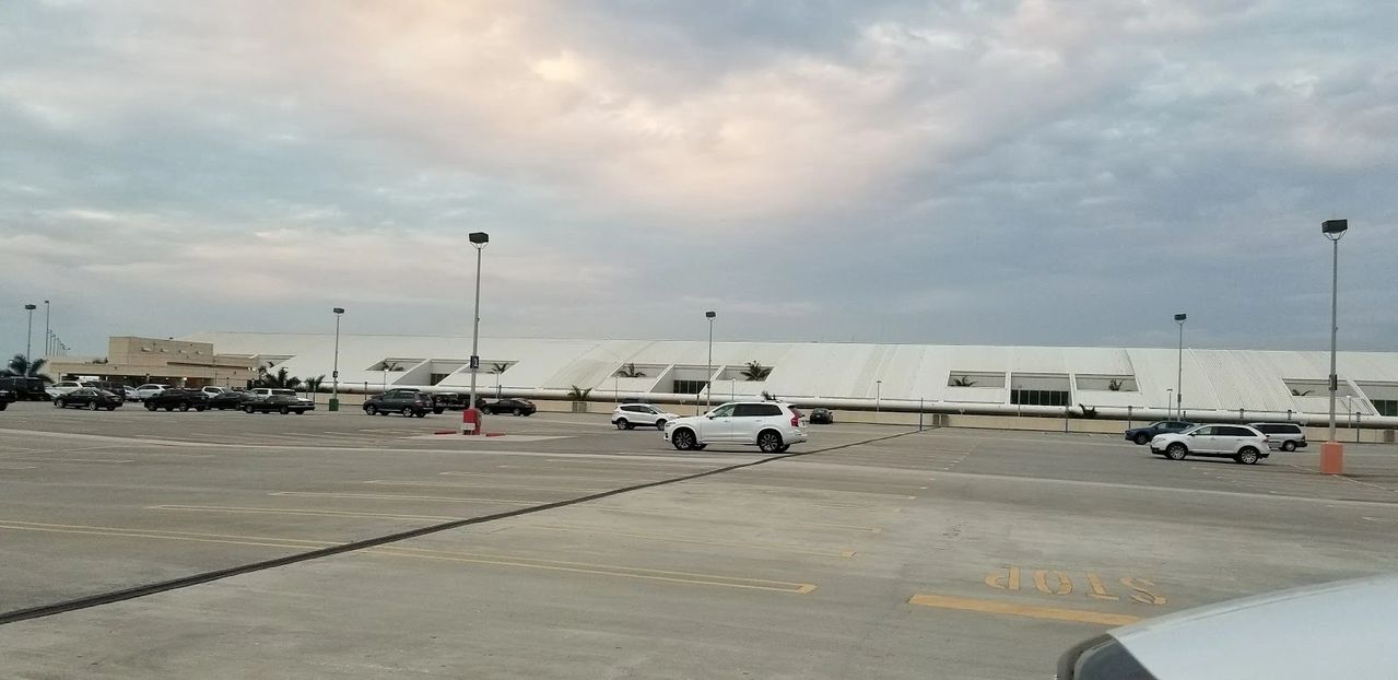 Airport parking lot with parked vehicles