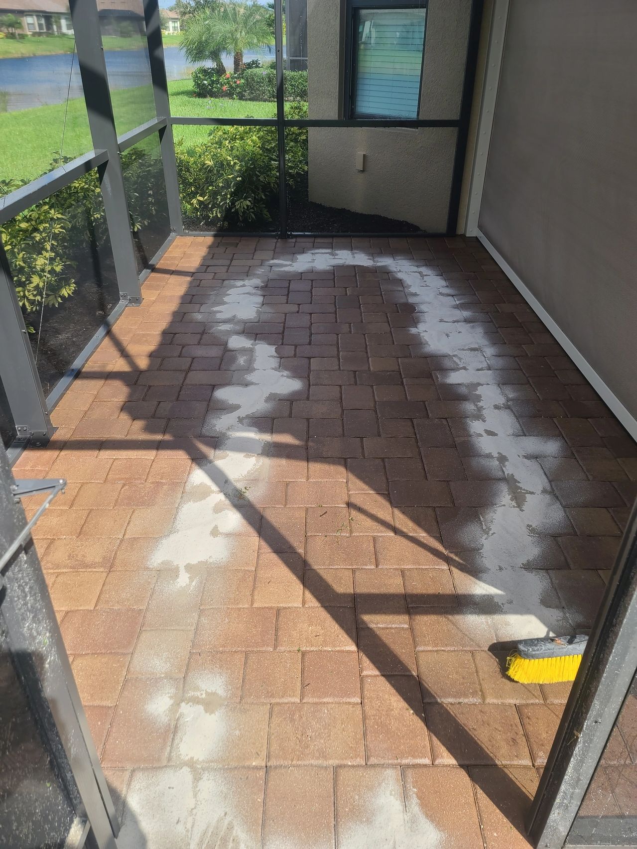 Paver patio with white powder and broom