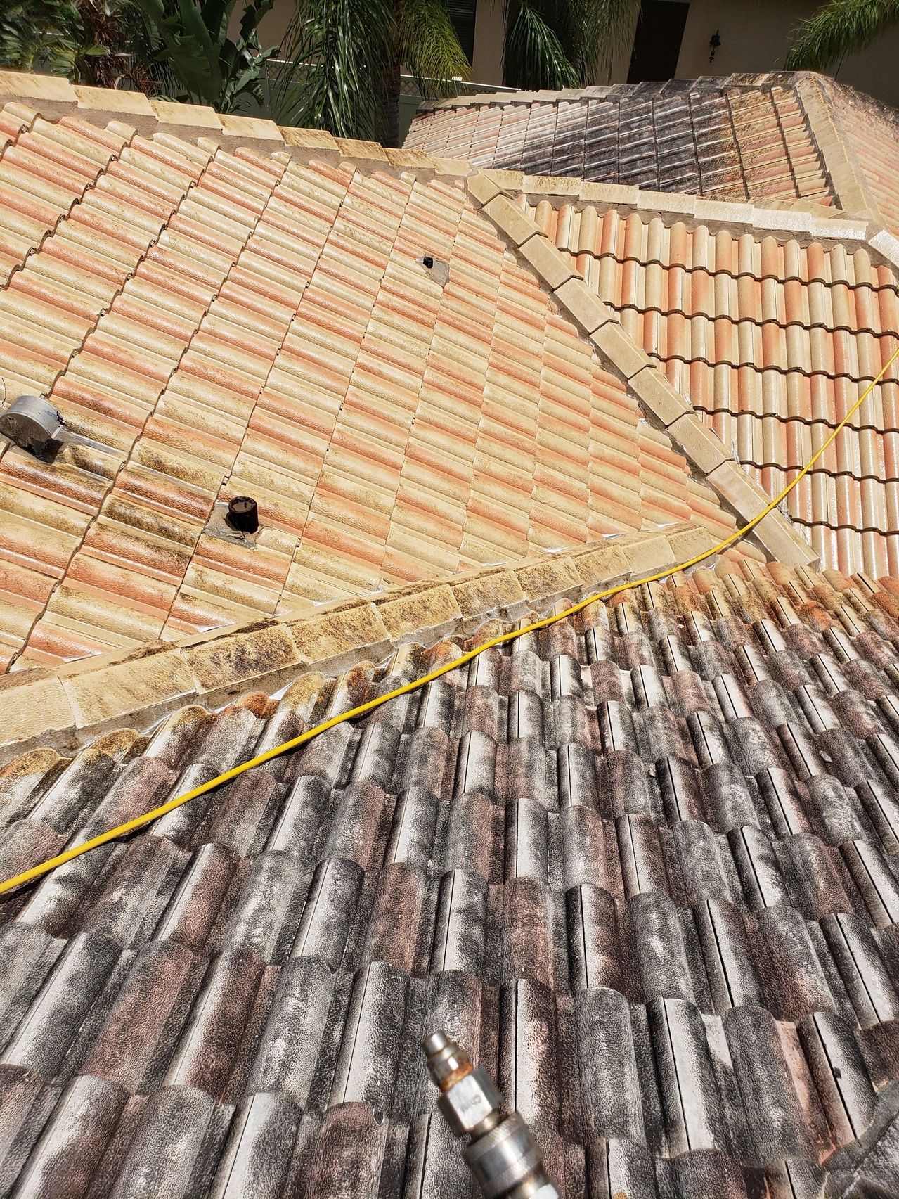 Weathered clay tile roofs with yellow cable
