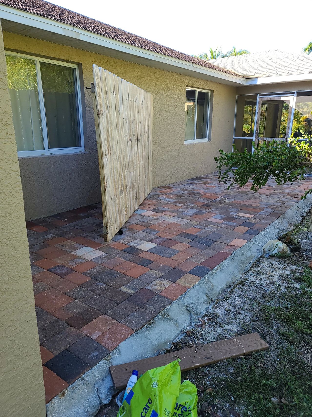 Newly paved patio with wooden gate