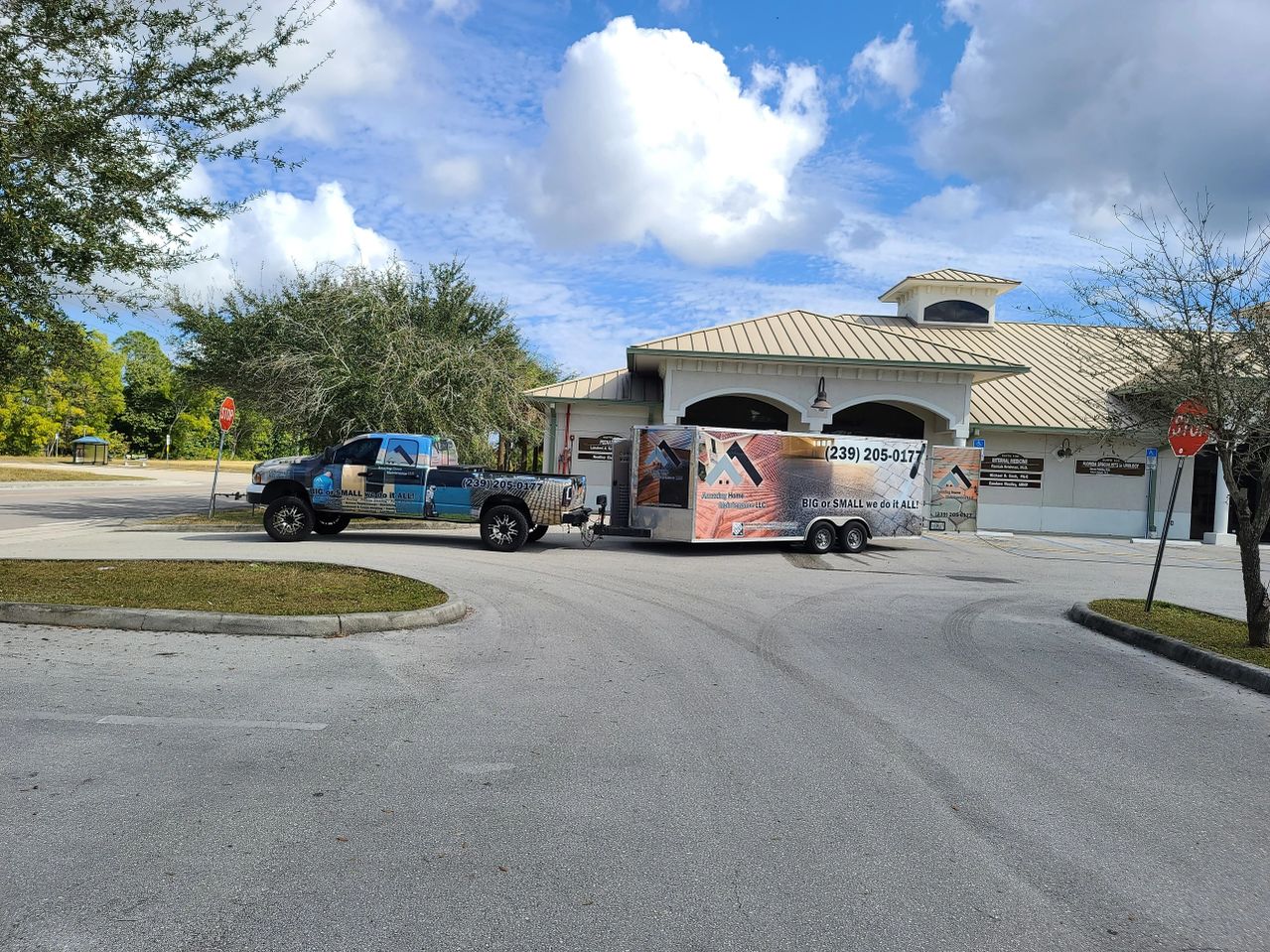 Pickup truck and branded trailer near building