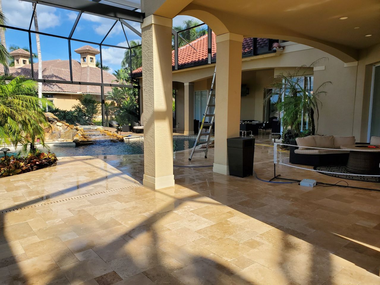 Covered patio with pool and tropical plants