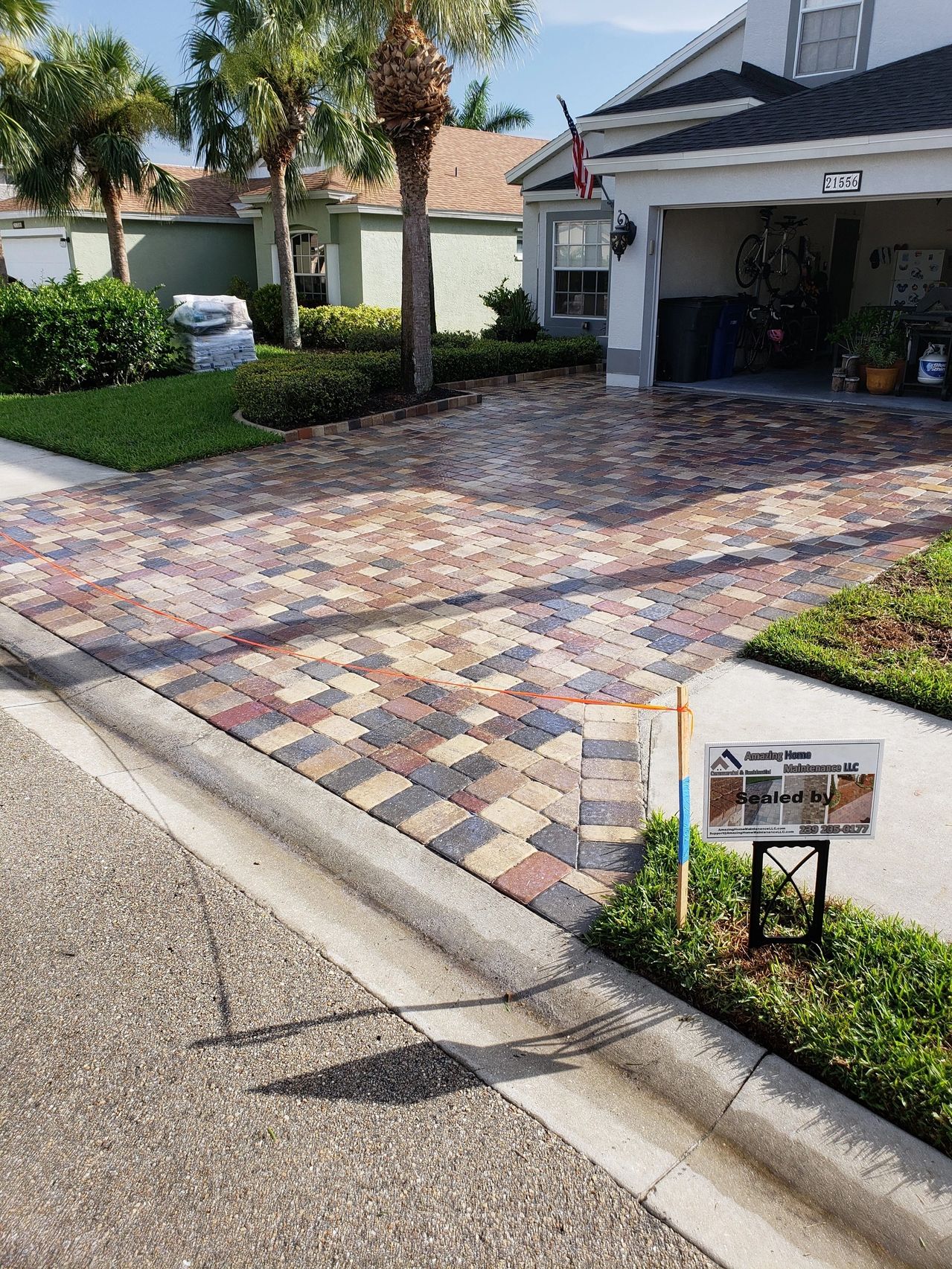 Sealed multicolored paver driveway at suburban home