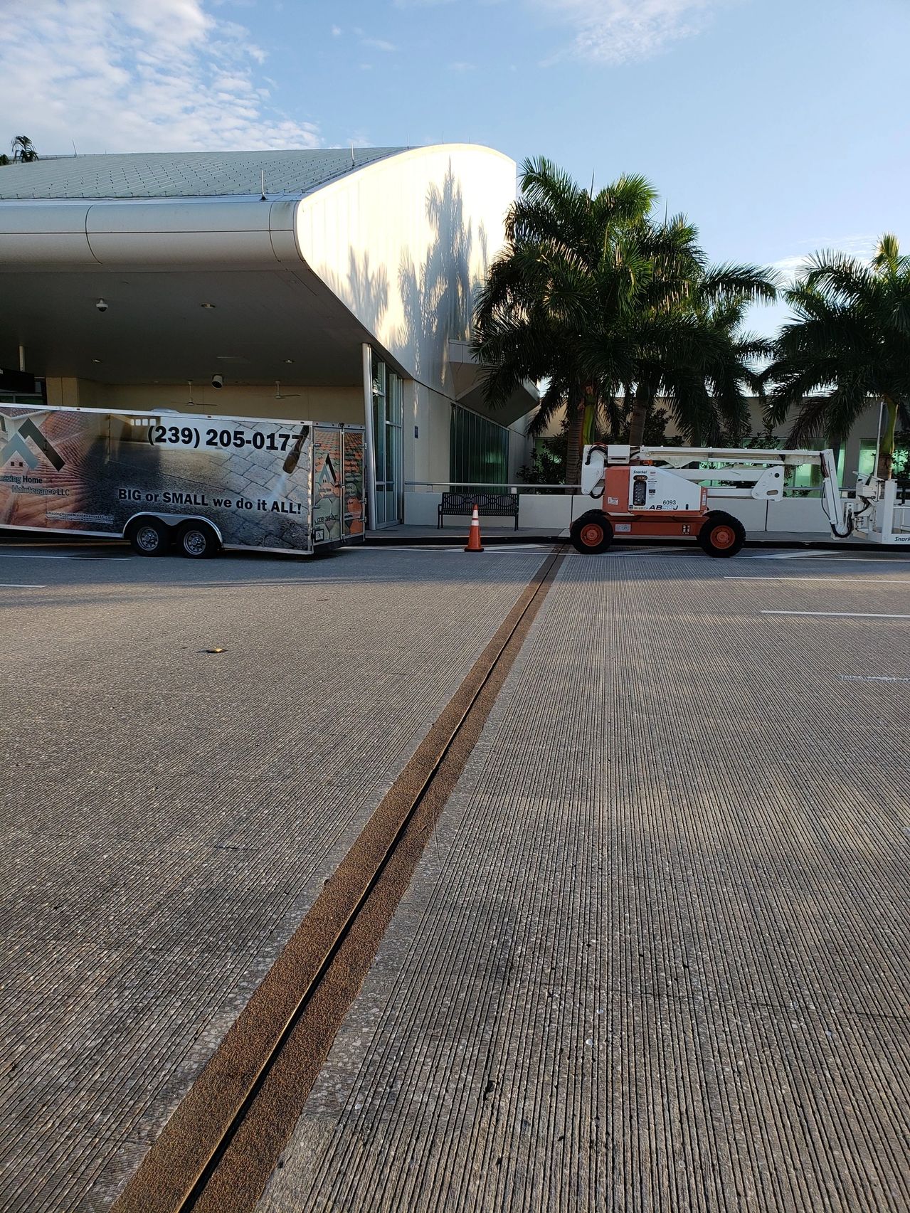 Service truck and trailer by modern building
